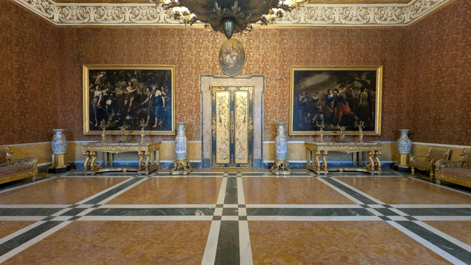 Grand hall of the Royal Palace of Naples with ornate paintings and gilded furniture